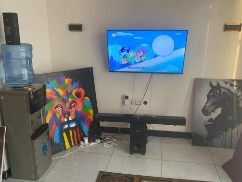 a room with a flat screen tv on a wall at Mtwapa behind mzuri sweet company in Mtwapa
