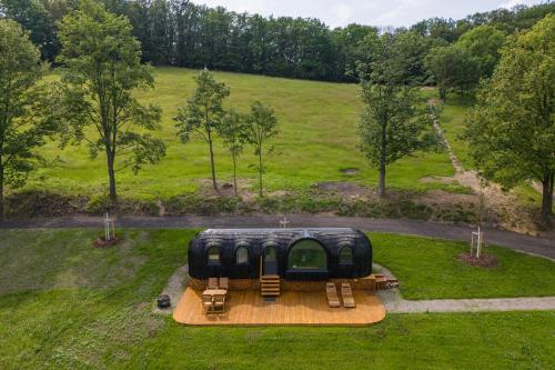 a tiny house in the middle of a field at Glamping Skrytín in Dobkovice