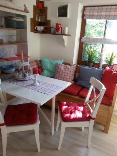 a living room with a table and a couch at Ferienwohnung Wiesmühlstrasse in Henndorf am Wallersee