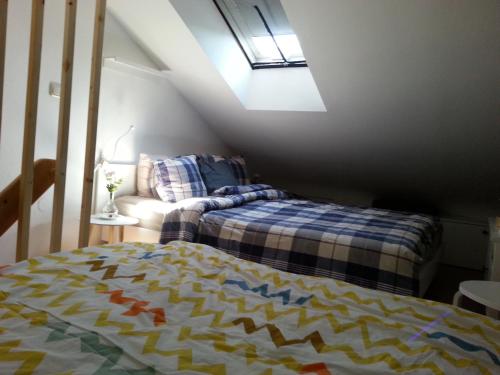 a attic bedroom with a bed and a couch at Ferienwohnung Wiesmühlstrasse in Henndorf am Wallersee