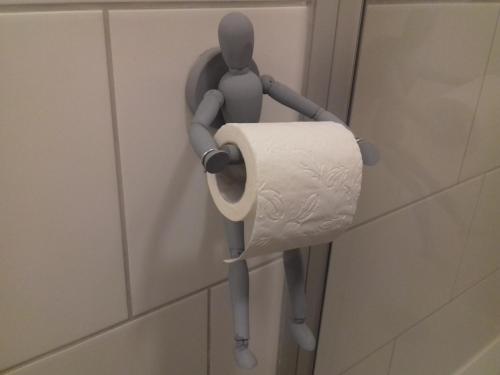 a toilet paper holder on a wall in a bathroom at Ferienwohnung Wiesmühlstrasse in Henndorf am Wallersee