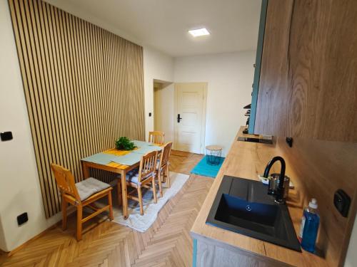 a kitchen and dining room with a table and a sink at Vila Mezi Časy in Trutnov