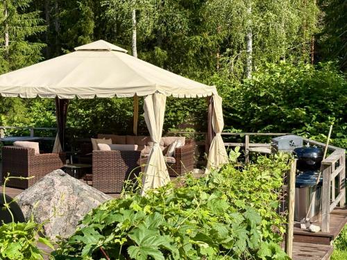 a gazebo in the middle of a garden at Björnåsen Bear Hill in Katrineholm