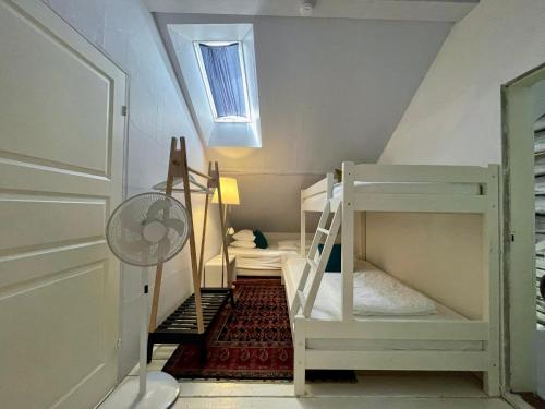 a attic room with a bunk bed and a window at Björnåsen Bear Hill in Katrineholm