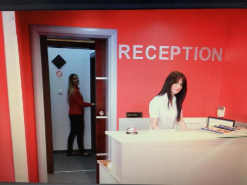 a woman standing in front of a counter in a room at Guesthouse Villa Modex in Paraćin