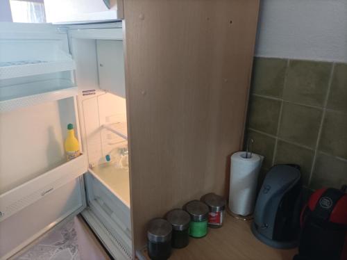 a small refrigerator with its door open and a trash can at The cave of Cyclops in Mákri