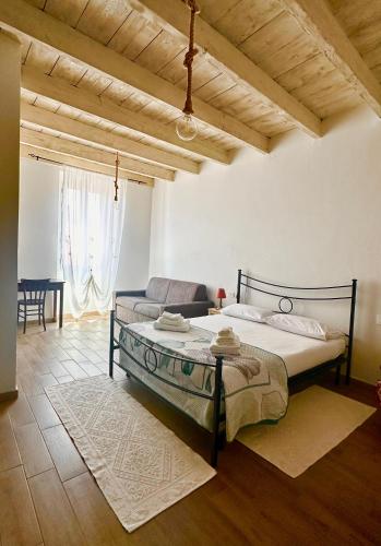 a bedroom with a bed and a couch at Austinu e Bingedda's Home in Ardara