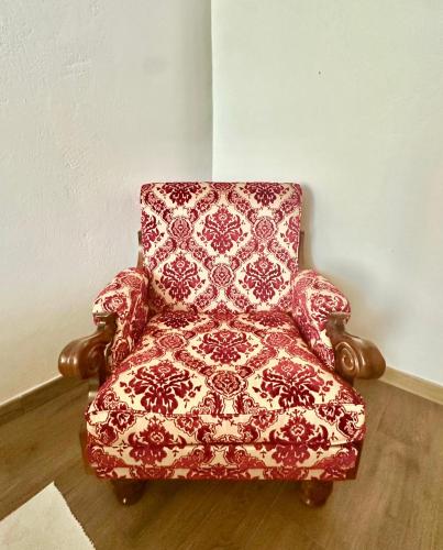 a red and white chair sitting in a room at Austinu e Bingedda's Home in Ardara
