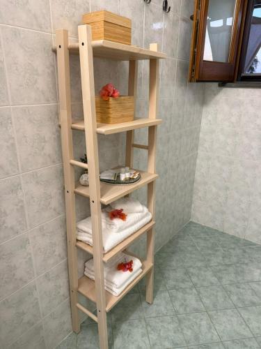 a wooden shelf in a bathroom with towels at CasaMirea in Lipari