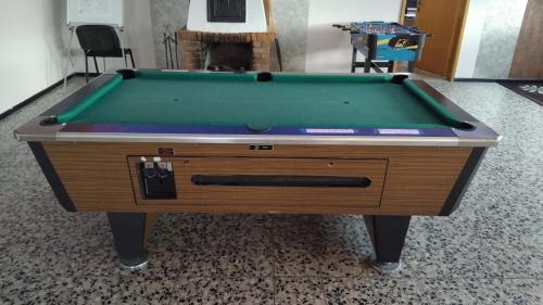 a pool table with a green cloth at Safari-Zelt Am Landwehrsee in Dörverden