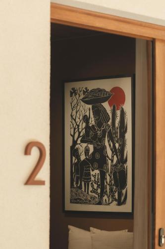 a framed picture of a woman with a mushroom at Pousada Casa Mandacaru Noronha in Fernando de Noronha