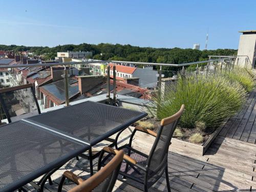 a black table and chairs on a balcony at Apartamenty Rondo in Świnoujście