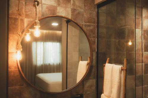 a bathroom with a large mirror and a sink at Pousada Casa Mandacaru Noronha in Fernando de Noronha