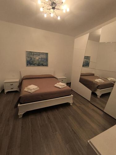 a bedroom with two beds and a chandelier at Casa del Sol in Leporano