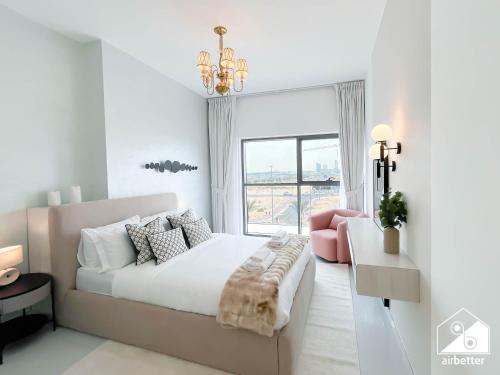 a white bedroom with a large bed and a pink chair at Bright 2Bed Family Home l Pool , Gym access in Dubai