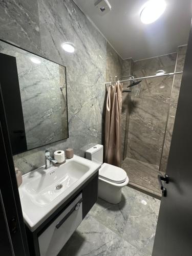 a bathroom with a sink and a toilet and a shower at Hotel black sea in K'obulet'i