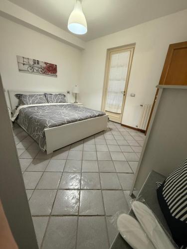 a bedroom with a bed and a tiled floor at The Happy Place Montecatini in Montecatini Terme