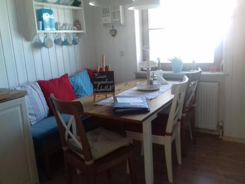a dining room table and chairs with a table and a couch at Ferienwohnung Wiesmühlstrasse in Henndorf am Wallersee