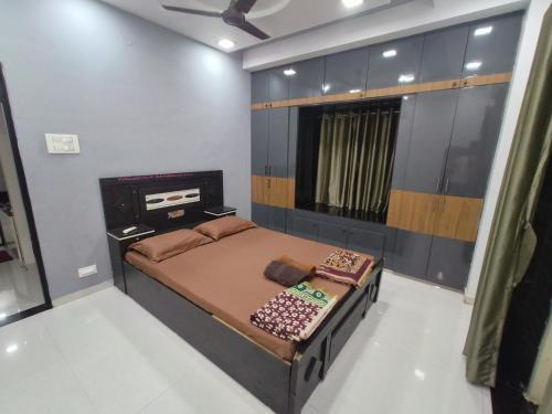 a small bedroom with a bed and a window at Solapur HomeStay By Stay Nestura in Solapur