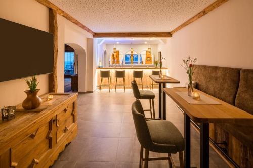 a living room with a couch and a bar at Naturhotel Alpenrose in Millstatt