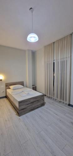 a bedroom with a large bed in a room at Hotel RADOJA in Shkodër
