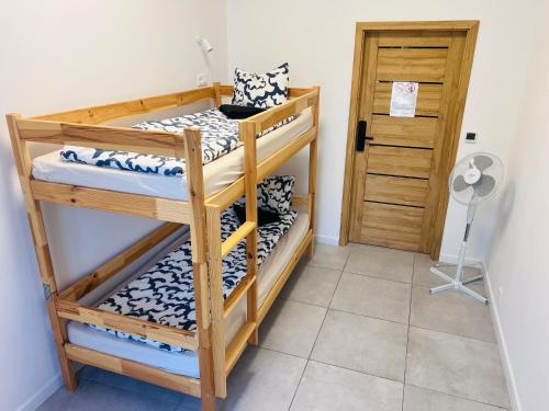 a room with three bunk beds and a door at Grand Hostel - Free Breakfast in Katowice