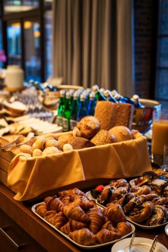 a table filled with different types of pastries and drinks at Hotel SPA Dr Irena Eris Wzgórza Dylewskie in Wysoka Wieś