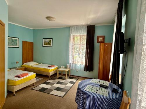 a room with two beds and a window in it at Rodar in Boguszów-Gorce