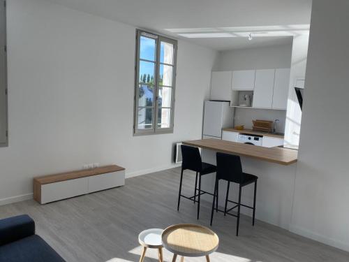 a kitchen and living room with a table and chairs at Studio Saint Louis - 2 personnes in Le Palais