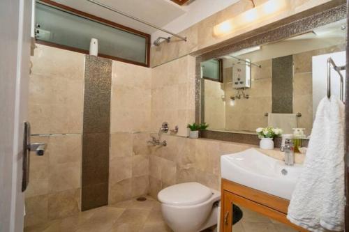 a bathroom with a toilet and a sink at Lake View 2BHK close to Mall Road l Bay Breeze in Nainital