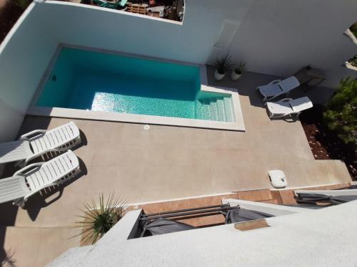 an overhead view of a swimming pool in a house at SEA YA - two apartments house with heated pool - 150m from beach in Zaglavice