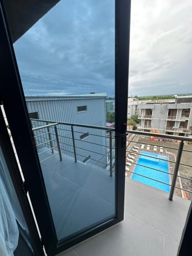 a balcony with a view of a swimming pool at Hotel black sea in K'obulet'i