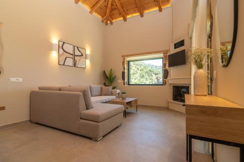 a living room with a couch and a chair at Aoria Villas in Palaiochóra