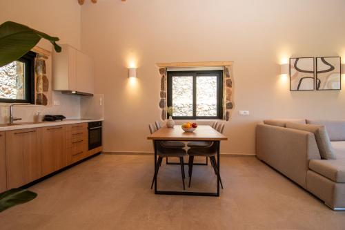 a kitchen and living room with a table and a couch at Aoria Villas in Palaiochóra