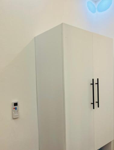 a white cabinet with two crosses on it at The Beauty and The Beach in Nagua
