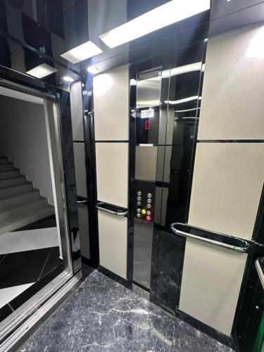 a elevator in a room with a door and stairs at Hotel black sea in K'obulet'i