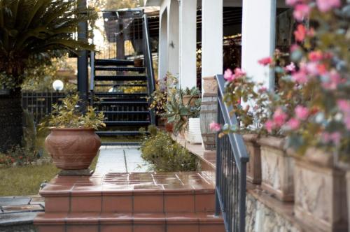 a porch with a vase of flowers and stairs at The Oaks in Spigno Saturnia
