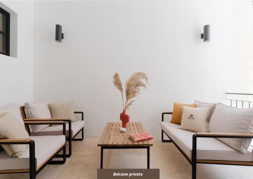 a living room with two couches and a table at Siviglia 70 Apartment - Lecce Selection in Lecce