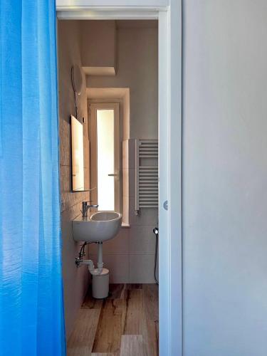 a bathroom with a sink and a mirror at Casa Enrico in Alassio