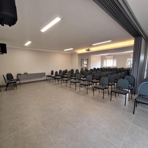 a large room with chairs and a podium in it at Fênix Plaza Hotel in Aquidauana