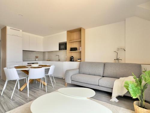 a living room with a couch and a table at La terraza da Braña in Villanueva de Arosa