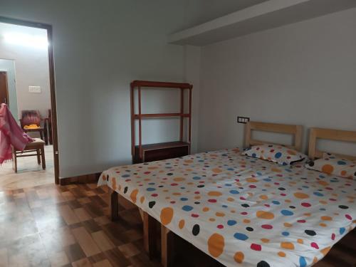 a bedroom with a bed with a colorful comforter at The Vedic Grove in Madhubani