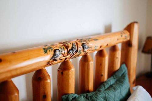 a wooden stair railing with a painting on it at TC Lake Stay-Pontoon & SUP Rentals - Sleeps 4! in Traverse City