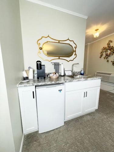 a kitchen with a sink and a mirror on the wall at Lowell Inn in Stillwater