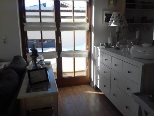 a kitchen with a large window and a white dresser at Ferienwohnung Wiesmühlstrasse in Henndorf am Wallersee