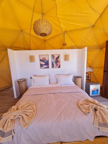 a bedroom with a large bed in a tent at Timlalin Dome in Tamri