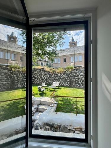 a view from a window of a yard at Maison Ombre du Clocher in Laguiole
