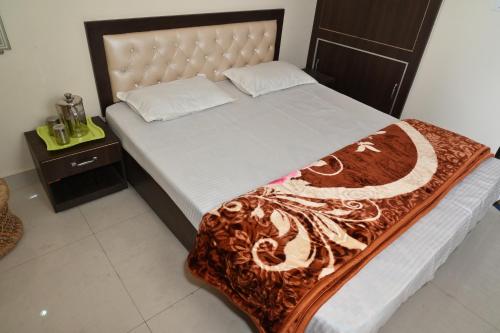 a bedroom with a large bed and a night stand at Thapliyal Homestay in Rishīkesh