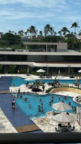 a group of people in a large swimming pool at Malia Beach 302 D - Muro Alto - Porto de Galinhas in Porto De Galinhas
