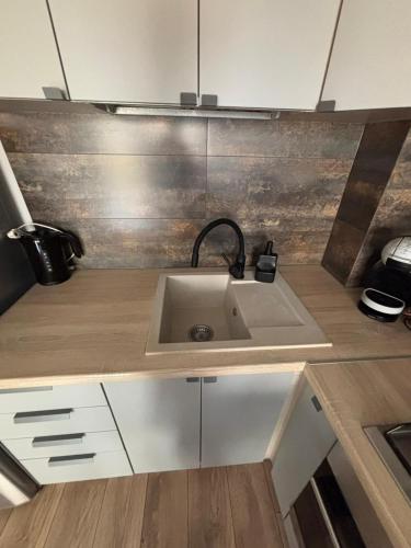 a kitchen with a sink and a counter top at Apartament Kossaka in Elblag